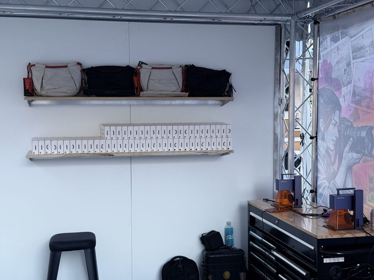Shelf of branded merch samples staged at a booth