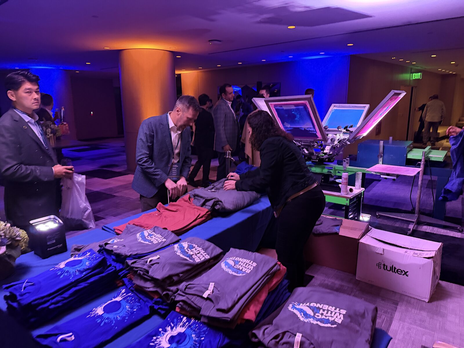 Executive summit merch table with curated printed apparel